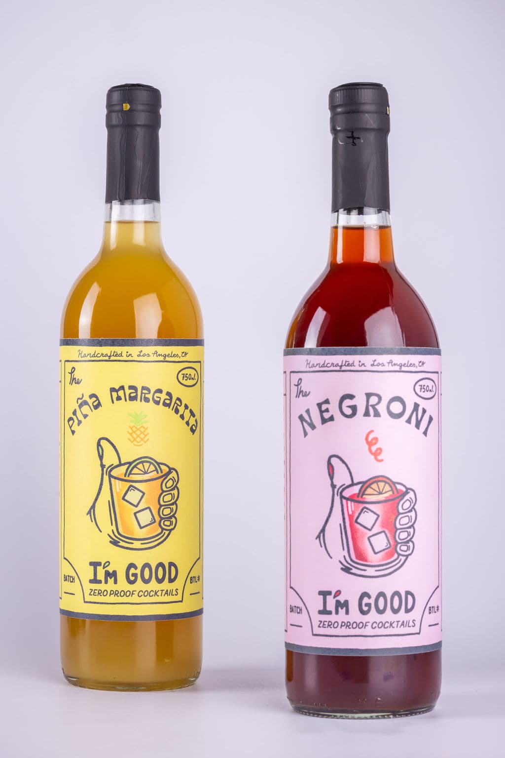 The Piña Margarita and The Negroni bottles standing side by side