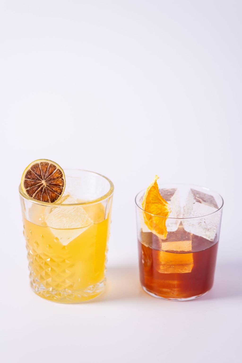 A Piña Margarita and a Negroni side by side over ice